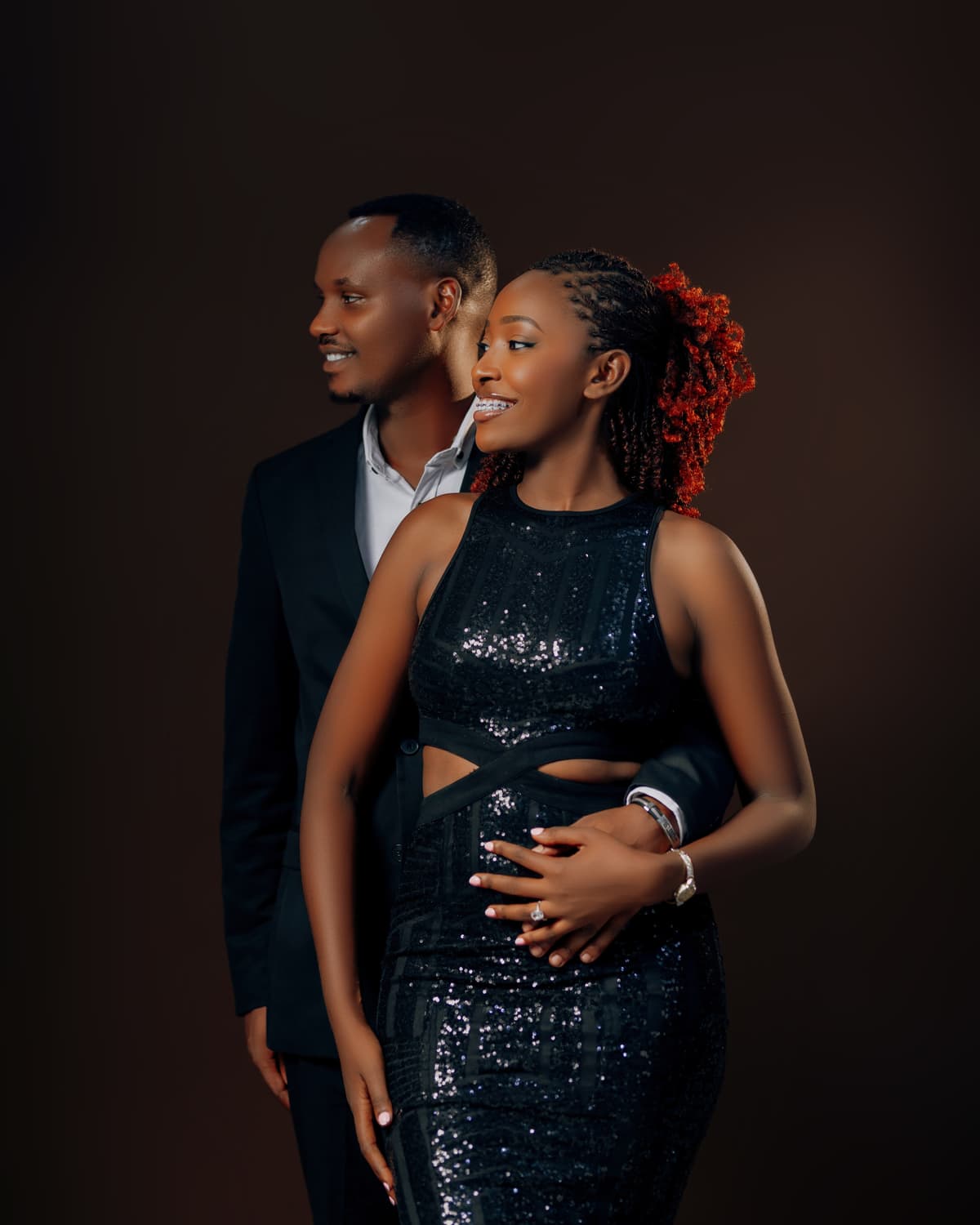 Celine smiling in a sequinned gown while Khalim holds her close
